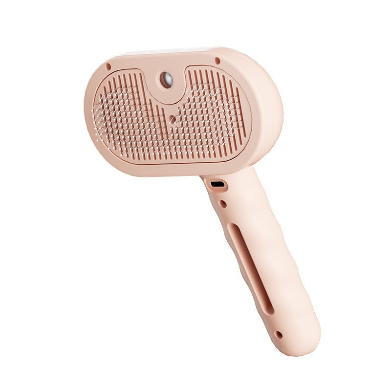 Pink pet grooming brush on a white background