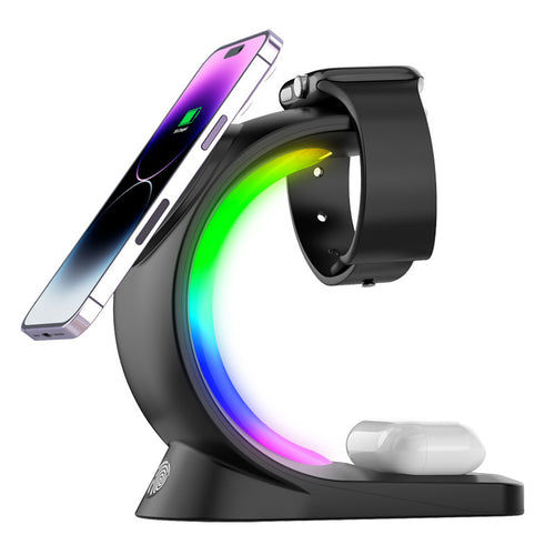 Black wireless charging stand with smartphone, smartwatch, and earbuds on a white background